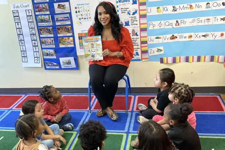 Y Head Start teacher reading to children